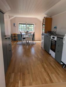 a kitchen with a table and a dining room at Gunnabo in Borgholm