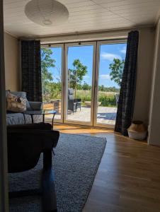 a living room with a view of a sliding glass door at Gunnabo in Borgholm