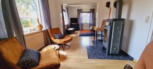 a living room with chairs and a wood stove at Quiet nice place Meine in Meine