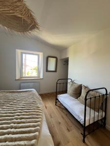 a bedroom with a bed and a window at La Grange d'Annalys in Granges-Narboz