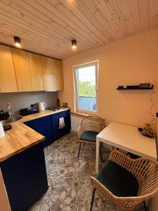 a kitchen with a table and chairs and a window at Cozy city apartments in Roja with free parking in Roja +4 photos