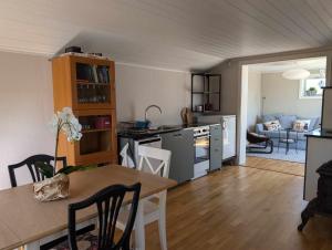 a kitchen and living room with a table and a dining room at Gunnabo in Borgholm