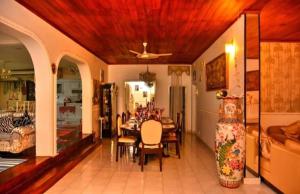 a dining room with a table and a living room at The Cinnamon Villa By Kings Bay in Negombo