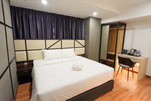 Postel nebo postele na pokoji v ubytování Merits Hotel Cameron Highlands