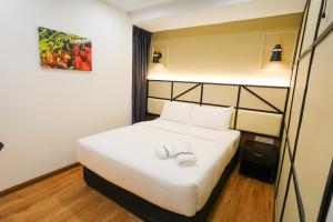 Postel nebo postele na pokoji v ubytování Merits Hotel Cameron Highlands