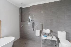 a bathroom with a white toilet and a shower at Shepherds Delight-Access Friendly-Linen Included in Goolwa South +37 photos
