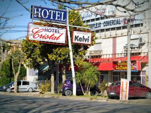 a sign for a hotel on a city street at Hotel Cristal in Viedma