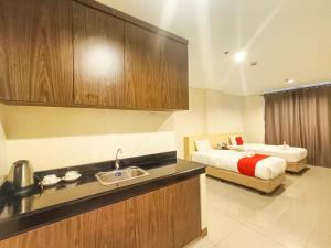 Ένα ή περισσότερα κρεβάτια σε δωμάτιο στο Kaizen Suites