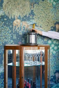 a bottle of wine on top of a table with wine glasses at Pariisin Ville in Porvoo