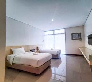 Ένα ή περισσότερα κρεβάτια σε δωμάτιο στο Kaizen Suites