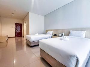 Ένα ή περισσότερα κρεβάτια σε δωμάτιο στο Kaizen Suites