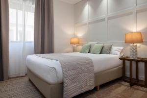 Posteľ alebo postele v izbe v ubytovaní Magno Apartments Muñoz Olivé