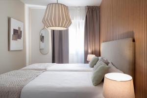 Posteľ alebo postele v izbe v ubytovaní Magno Apartments Muñoz Olivé