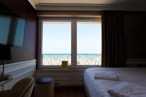 Postel nebo postele na pokoji v ubytování Hôtel Merveilleux Côté Mer