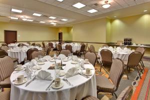 a banquet room with white tables and chairs at Holiday Inn & Suites Bakersfield, an IHG Hotel in Bakersfield