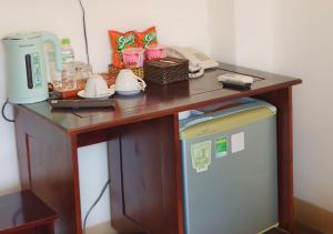 a wooden table with a desk with a telephone at Sontra Sea Hotel in Danang