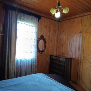 a bedroom with a bed and a window at Дом для отдыха близко Батуми in Batumi