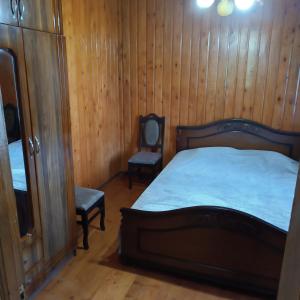 a bedroom with a bed and a chair in it at Дом для отдыха близко Батуми in Batumi