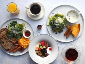 a table with plates of food and a cup of coffee at BIRD HOTEL in Kamakura