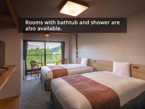 Postel nebo postele na pokoji v ubytování KAMENOI HOTEL Okunikko