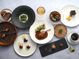 a table topped with plates of food and drinks at BIRD HOTEL in Kamakura