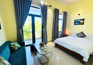 a bedroom with a bed and a large window at Sontra Sea Hotel in Danang