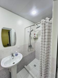 a bathroom with a sink and a shower at MrShox Hostel 1 in Samarkand