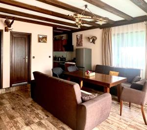 a living room with a couch and a table at Villa Capricorn in Tsigov Chark