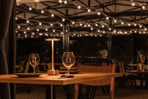a table with wine glasses and lights on a patio at BIRD HOTEL in Kamakura