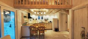 a kitchen with a table and chairs in a room at Chrisanthi's Cottage in Mougkelátika