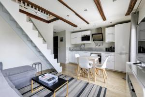 a living room with a couch and a table at Paris - Cosy Duplex près des Champs Elysées in Neuilly-sur-Seine
