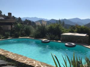 a swimming pool with mountains in the background at Love Room Villa Charlene in Massoins