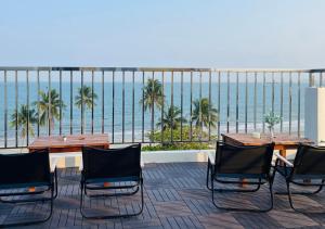 a patio with tables and chairs and the ocean at Sontra Sea Hotel in Danang