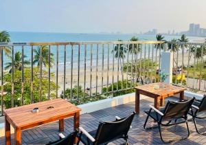 a balcony with two tables and chairs and the beach at Sontra Sea Hotel in Danang