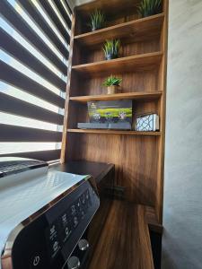 a kitchen with wooden shelves with plants on them at SeaView Lazur Apartment in Burgas City