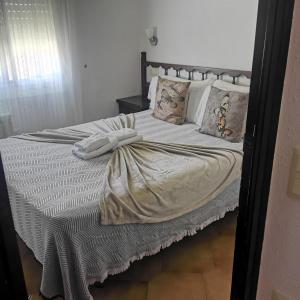 a bed with two pillows and a blanket on it at Finca Bella Terra in Camarles +13 photos