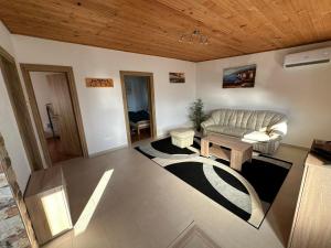 a living room with a couch and a table at White Apartman in Dobra Voda
