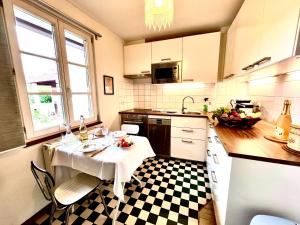a kitchen with a table with a white table cloth at La Maison de Caroline in Westhoffen