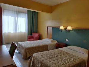 Postelja oz. postelje v sobi nastanitve Albergo Conte Max