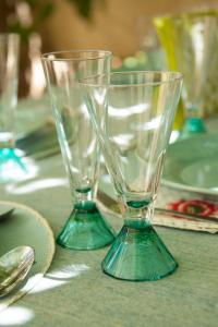 two empty glasses sitting on top of a table at Maison Pelissier Bed and Breakfast with swemming pool in Cuxac-dʼAude