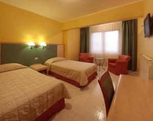Postelja oz. postelje v sobi nastanitve Albergo Conte Max