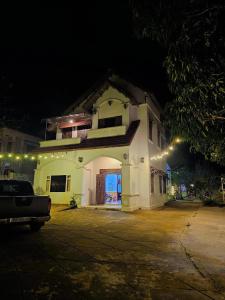 a white building with lights on it at night at Roll Huynh in Kon Plong +4 photos