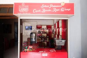 a store with a red sign on the front of it at Griya Jasmine Syariah Seturan RedPartner in Yogyakarta +19 photos