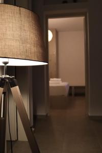 a lamp in a room with a bathroom at Antigoni Villas in Gavrio