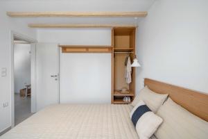 a bedroom with a bed and a sliding door at Perla's Luxury Apartments in Livadi