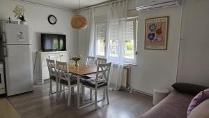 a kitchen and dining room with a table and chairs at St Anthony's House with Parking in Zagreb