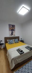 a bedroom with a bed with two pillows on it at Knezevic House in Gevgelija