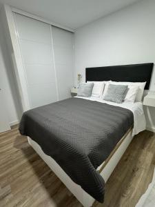 a bedroom with a large bed with white walls at Linerlife in Málaga