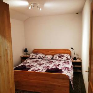 a bedroom with a bed with a wooden frame at Kuća za odmor Tomislav in Trnovdc