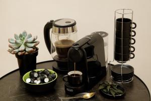 a coffee maker sitting on a table with a bowl of food at The Right Place 4U Piemonte Apartment in Rome